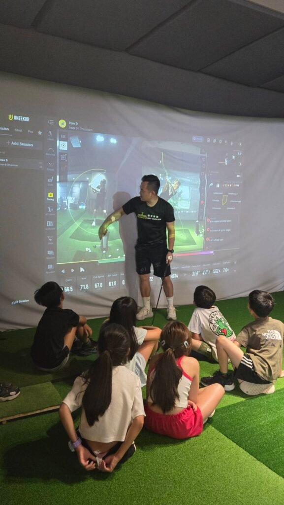 Good Good English students using English during a golf simulator class